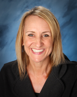  Woman wearing black with blonde hair smiling at the camera
